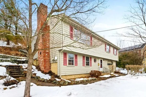 a front view of a building with snow on the road