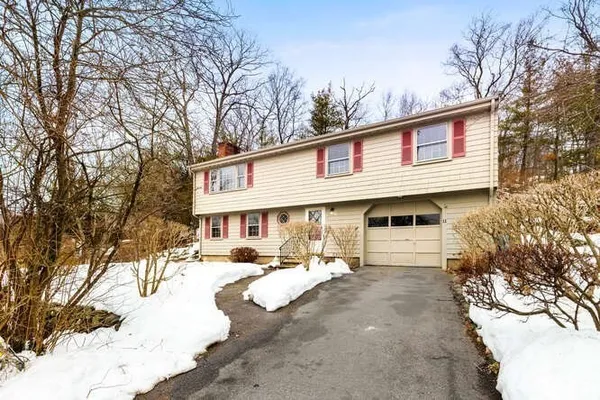 a front view of a house with a yard covered in snow
