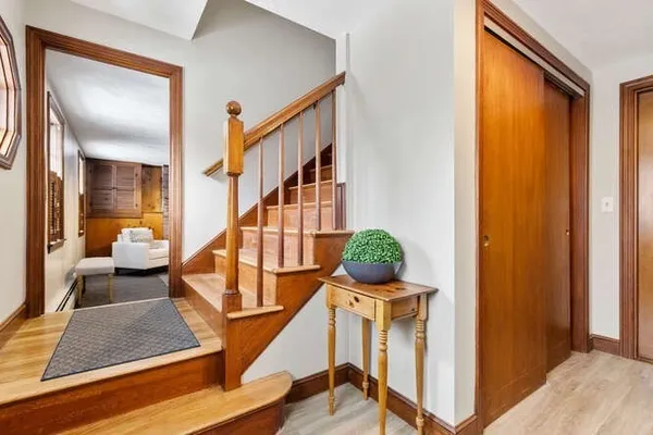 a view of staircase with furniture and a window