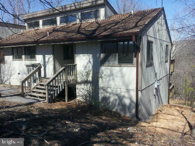 260 McCoys Ford Road Front Royal, VA 22630 - Photo 2 of 5 a view of a house with a wooden fence