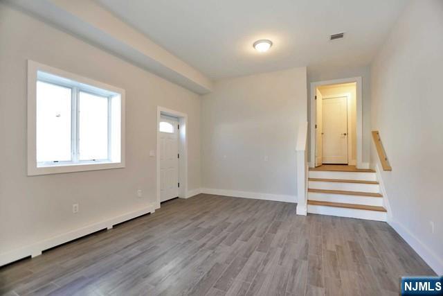 463 Roff Avenue, Unit B Palisades Park, NJ 07650 - Photo 14 of 23 a view of empty room with wooden floor and fan
