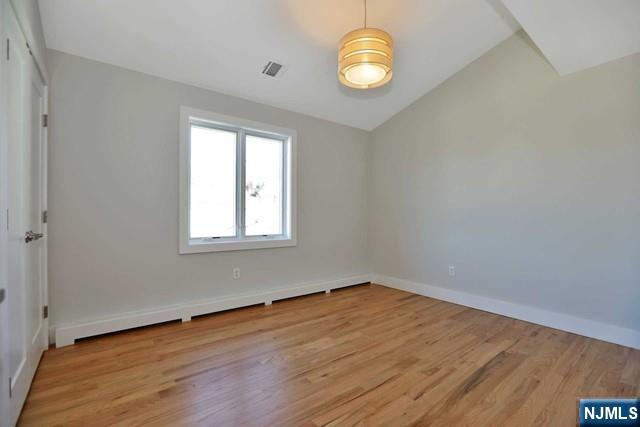 463 Roff Avenue, Unit B Palisades Park, NJ 07650 - Photo 16 of 23 an empty room with wooden floor and windows