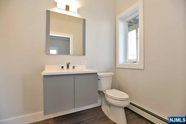 463 Roff Avenue, Unit B Palisades Park, NJ 07650 - Photo 18 of 23 a bathroom with a toilet a sink a mirror and a window