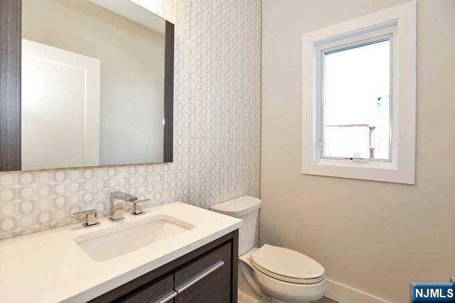 463 Roff Avenue, Unit B Palisades Park, NJ 07650 - Photo 19 of 23 a bathroom with a sink a toilet and mirror