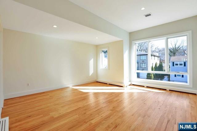 463 Roff Avenue, Unit B Palisades Park, NJ 07650 - Photo 2 of 23 a view of an empty room with wooden floor and a window