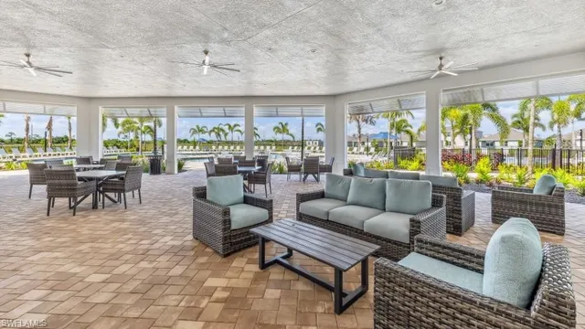 a living room with furniture and a floor to ceiling window