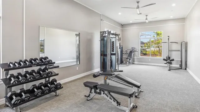 a room with gym equipment and a large mirror on the desk