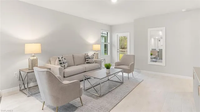 a living room with furniture and a lamp