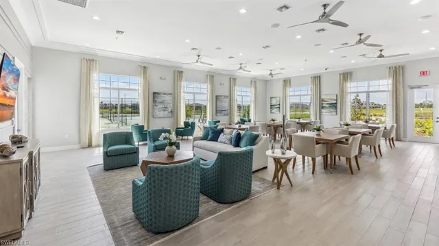 a living room with patio furniture and a large window