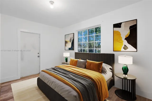 a bedroom with a bed and painting on the wall