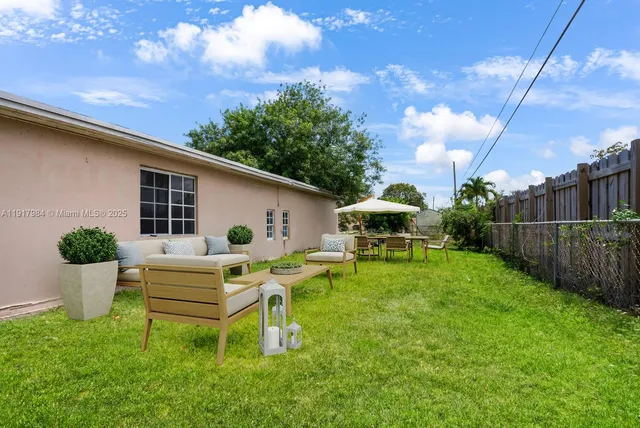 a view of a house with backyard sitting area and garden