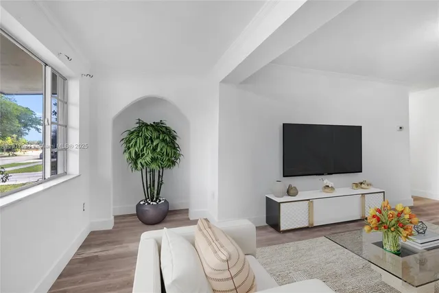 a living room with furniture and flat screen tv