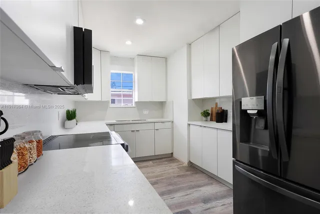 a kitchen with a refrigerator and a sink