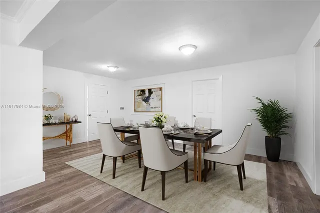 a view of a dining room with furniture and a potted plant
