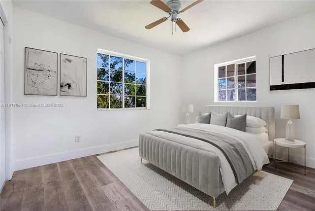 a bedroom with a large bed and a window