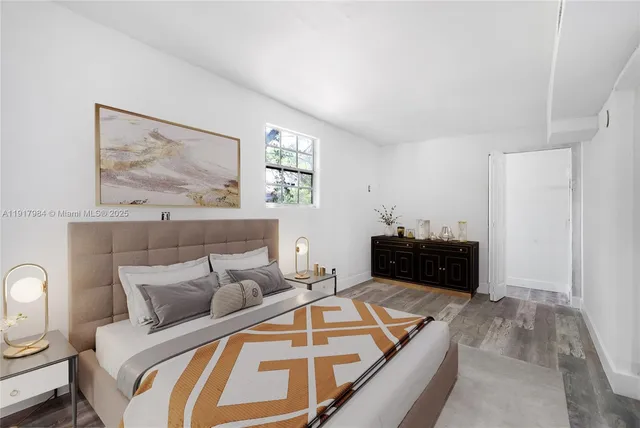 a bedroom with a bed and a painting on the wall