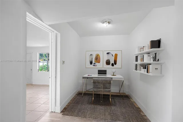 a workspace room with furniture and book shelf