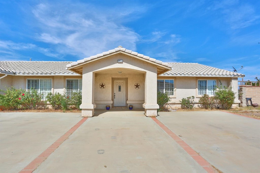 5455 Coleridge Road Oak Hills, CA 92344 - Photo 1 of 1 a front view of a house with yard and porch