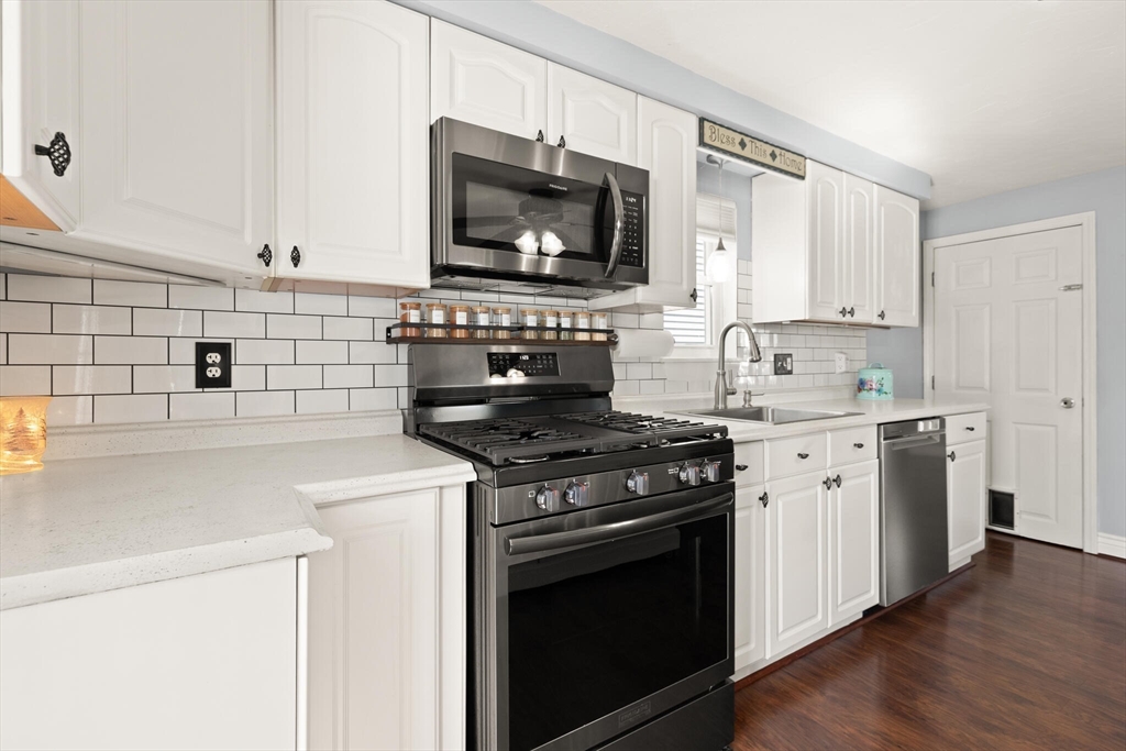 19 Cherry Street Hudson, MA 01749 - Photo 13 of 28 a kitchen with stainless steel appliances a sink stove and microwave