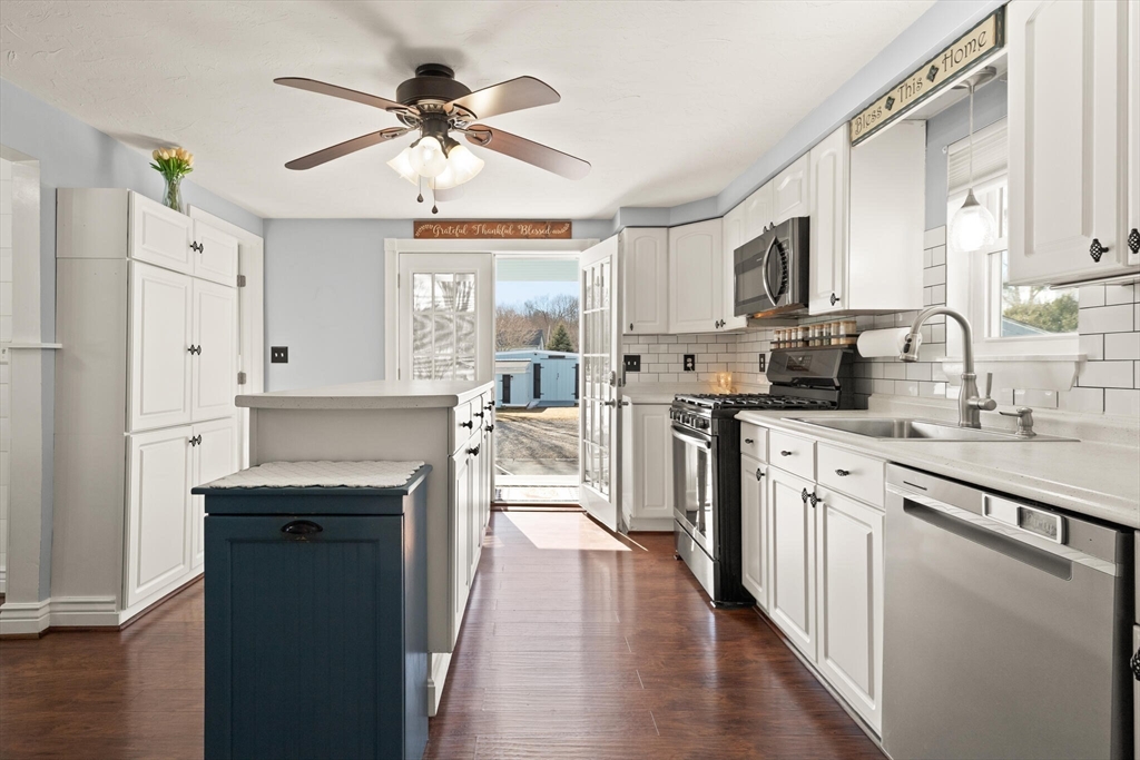 19 Cherry Street Hudson, MA 01749 - Photo 14 of 28 a kitchen with stainless steel appliances granite countertop a sink stove and refrigerator