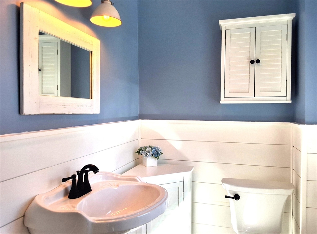 19 Cherry Street Hudson, MA 01749 - Photo 15 of 28 a bathroom with a sink and a mirror