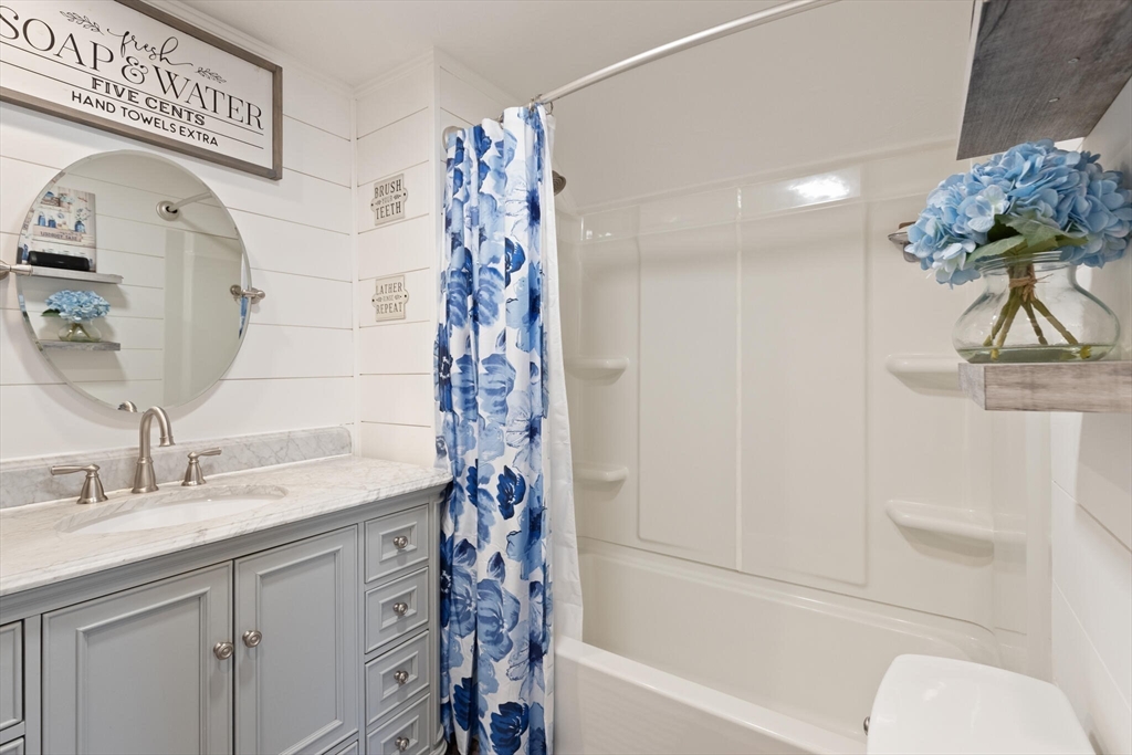 19 Cherry Street Hudson, MA 01749 - Photo 24 of 28 a bathroom with a sink a toilet and a bathtub