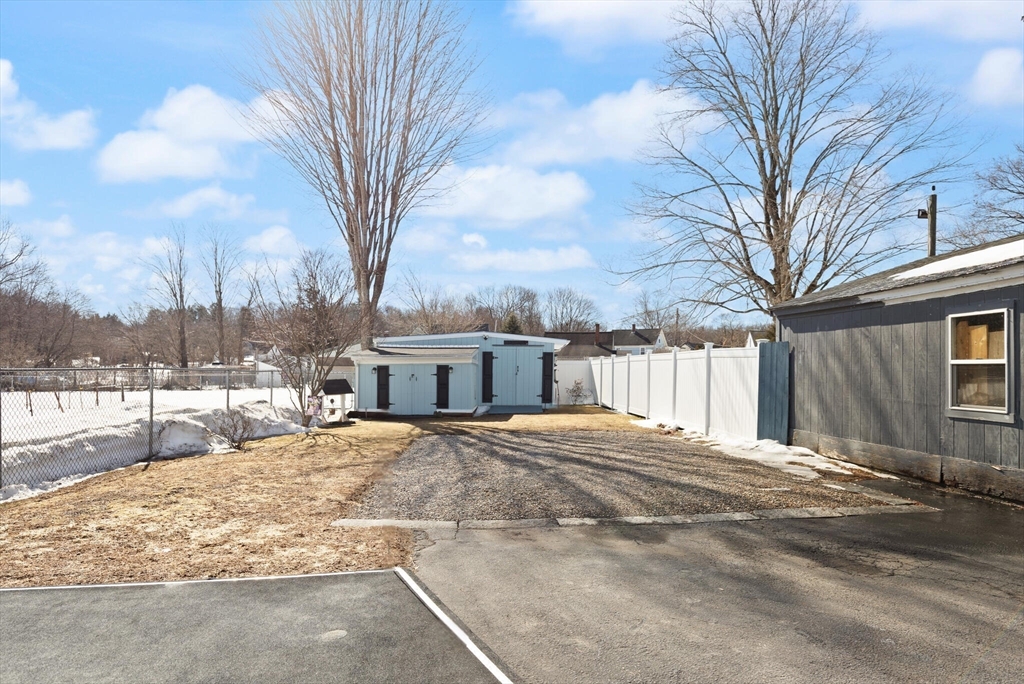 19 Cherry Street Hudson, MA 01749 - Photo 25 of 28 a backyard of a house with a large tree