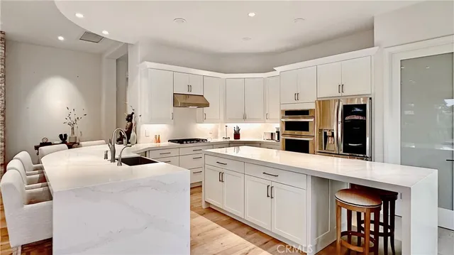 a kitchen that has a lot of cabinets in it and appliances
