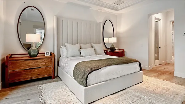 a bedroom with bed and a mirror