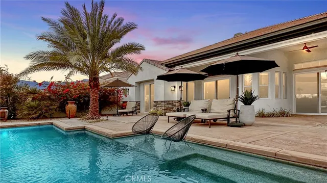 a view of a backyard with sitting area