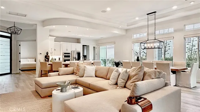 a living room with furniture chandelier and a chandelier