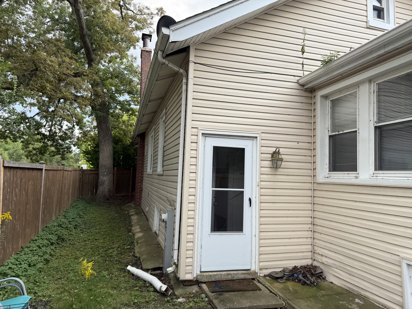 979 Vine Street Winnetka, IL 60093 - Photo 12 of 18 a view of a white house with a small yard and wooden fence