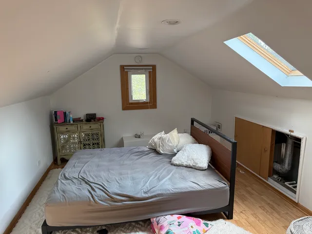 a bedroom with a bed and flat screen tv