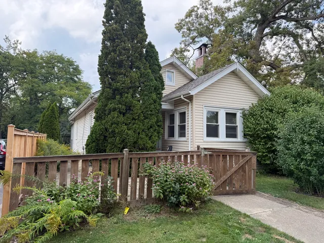 a house with a small yard and wooden fence