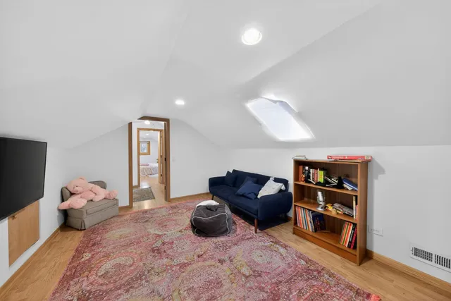 a living room with furniture a rug and a flat screen tv