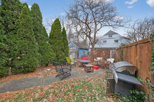 a view of a chairs and tables in the back yard of the house
