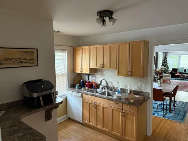 a kitchen with a window a sink and a stove