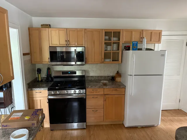 a kitchen with a refrigerator stove and microwave