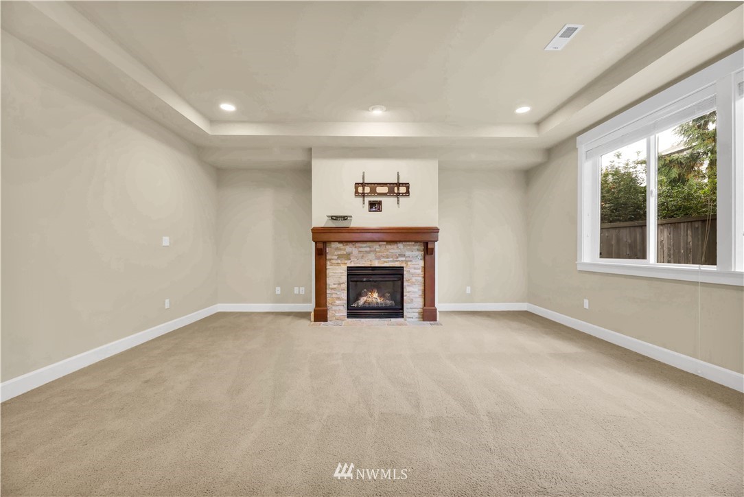 6117 Northeast 1st Street Renton, WA 98059 - Photo 11 of 39 a view of an empty room with a fireplace and a window