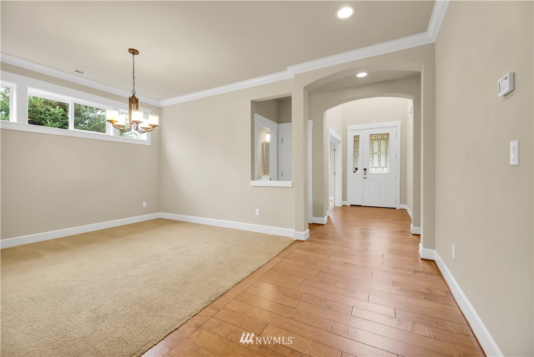 6117 Northeast 1st Street Renton, WA 98059 - Photo 13 of 39 a view of a room with wooden floor chandelier and entryway