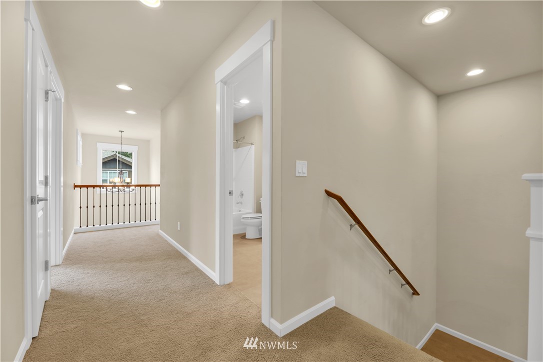 6117 Northeast 1st Street Renton, WA 98059 - Photo 25 of 39 a view of a hallway with windows and stairs
