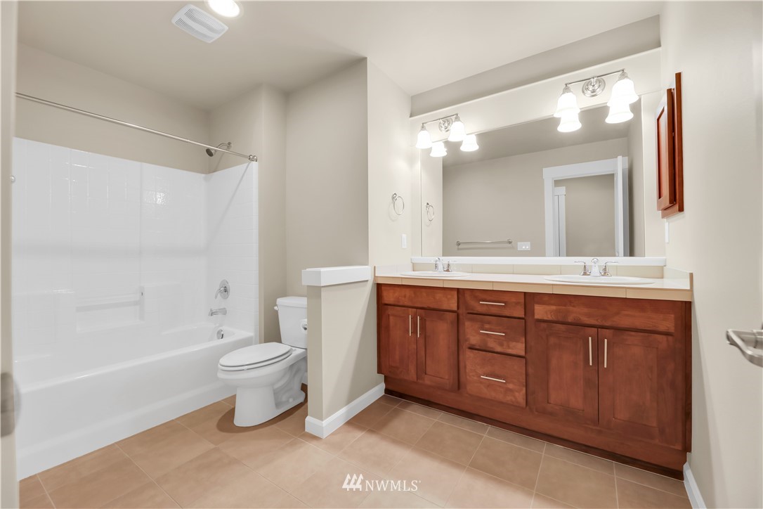 6117 Northeast 1st Street Renton, WA 98059 - Photo 26 of 39 a spacious bathroom with a bathtub shower sink mirror and toilet