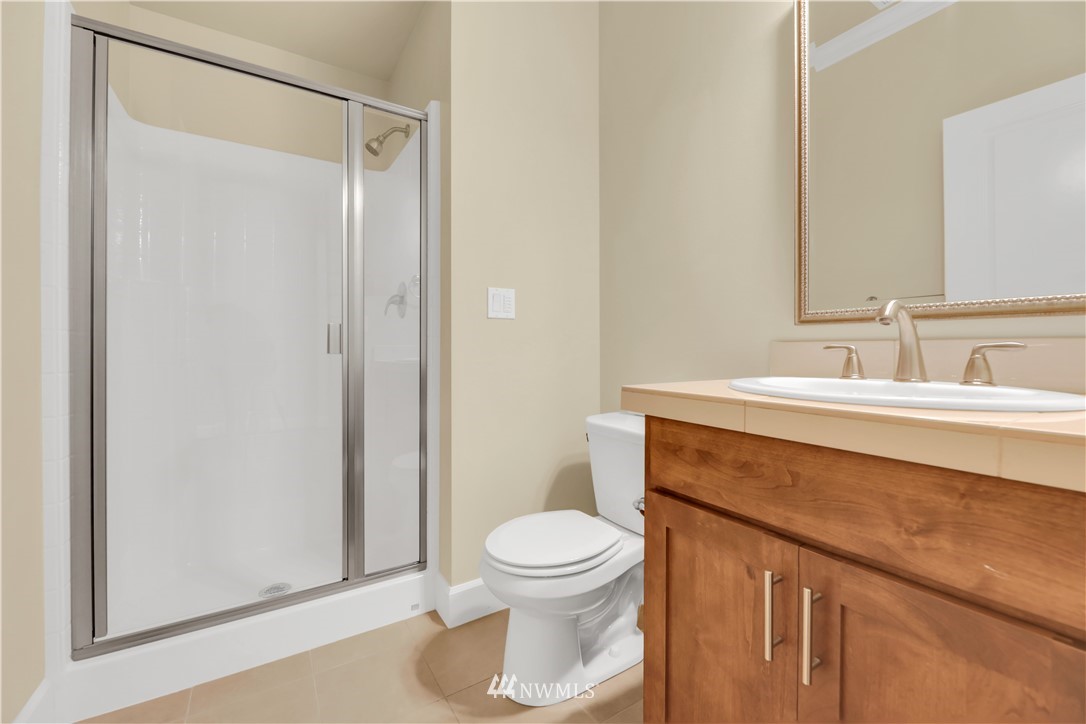 6117 Northeast 1st Street Renton, WA 98059 - Photo 4 of 39 a bathroom with a sink a toilet and shower
