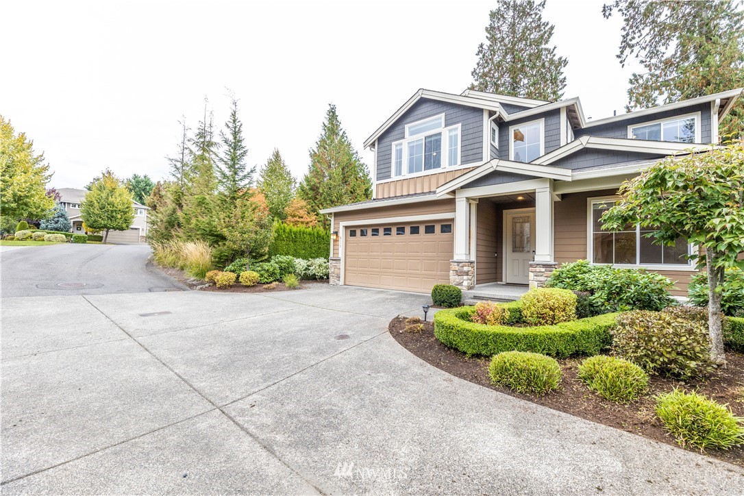6117 Northeast 1st Street Renton, WA 98059 - Photo 34 of 39 a front view of a house with a yard and garage