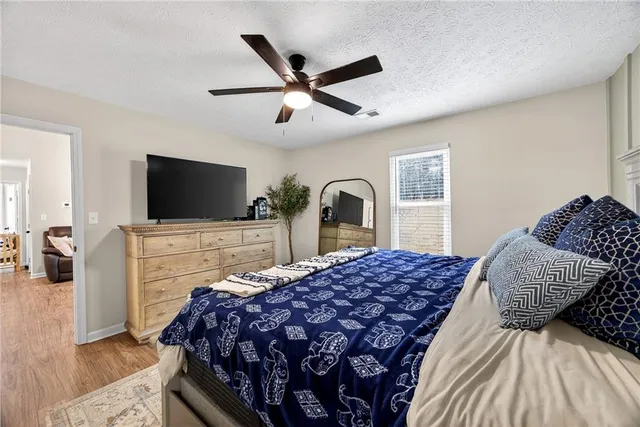 a bedroom with a large bed and a flat screen tv