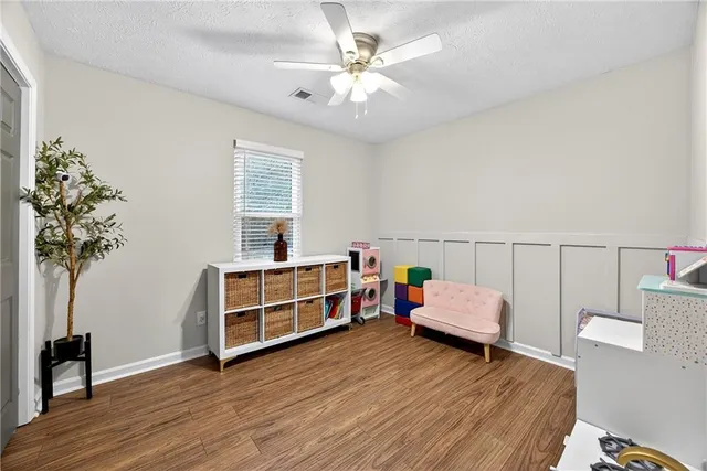 a bedroom with furniture and a potted plant