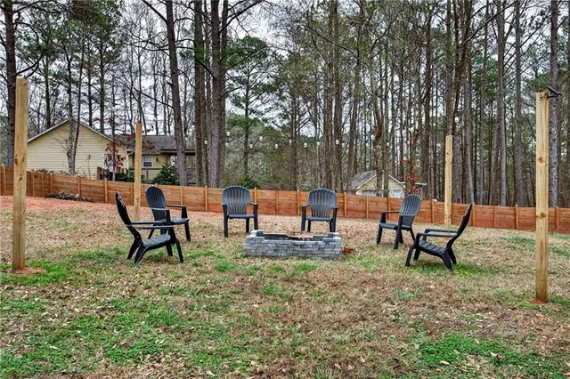 a backyard of a house with table and chairs