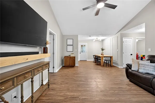 a living room with furniture and a dining table