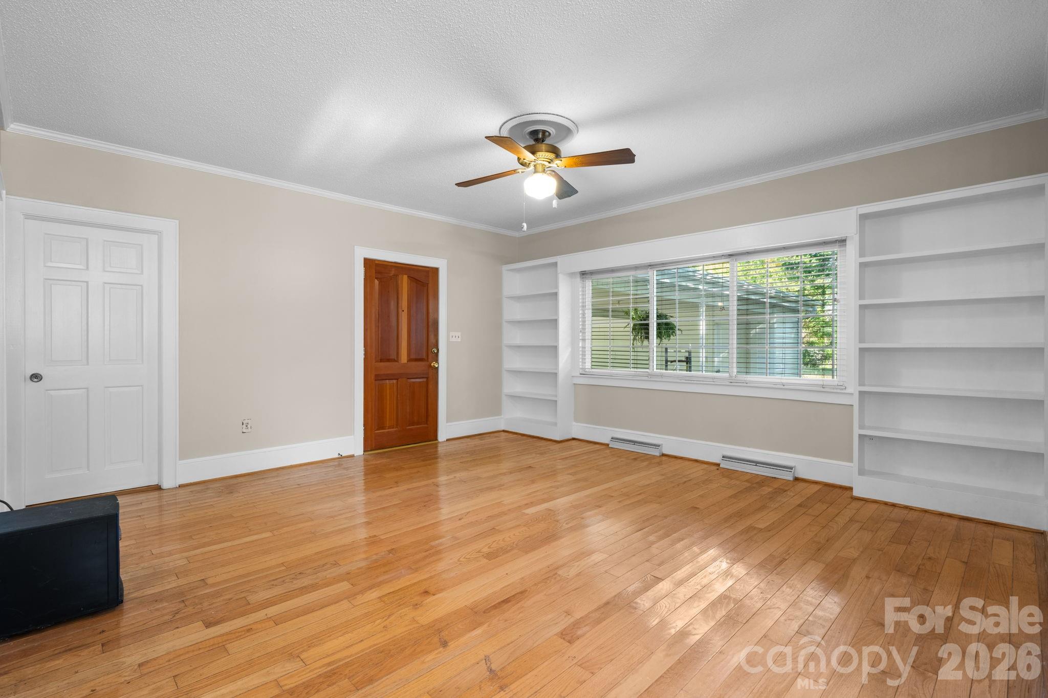 144 Hunter Bridge Road Stony Point, NC 28678 - Photo 5 of 45 a view of empty room with wooden floor and fan