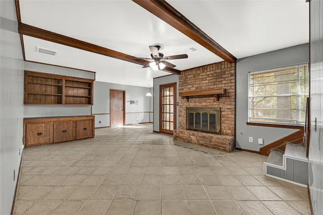 a view of an empty room with a fireplace